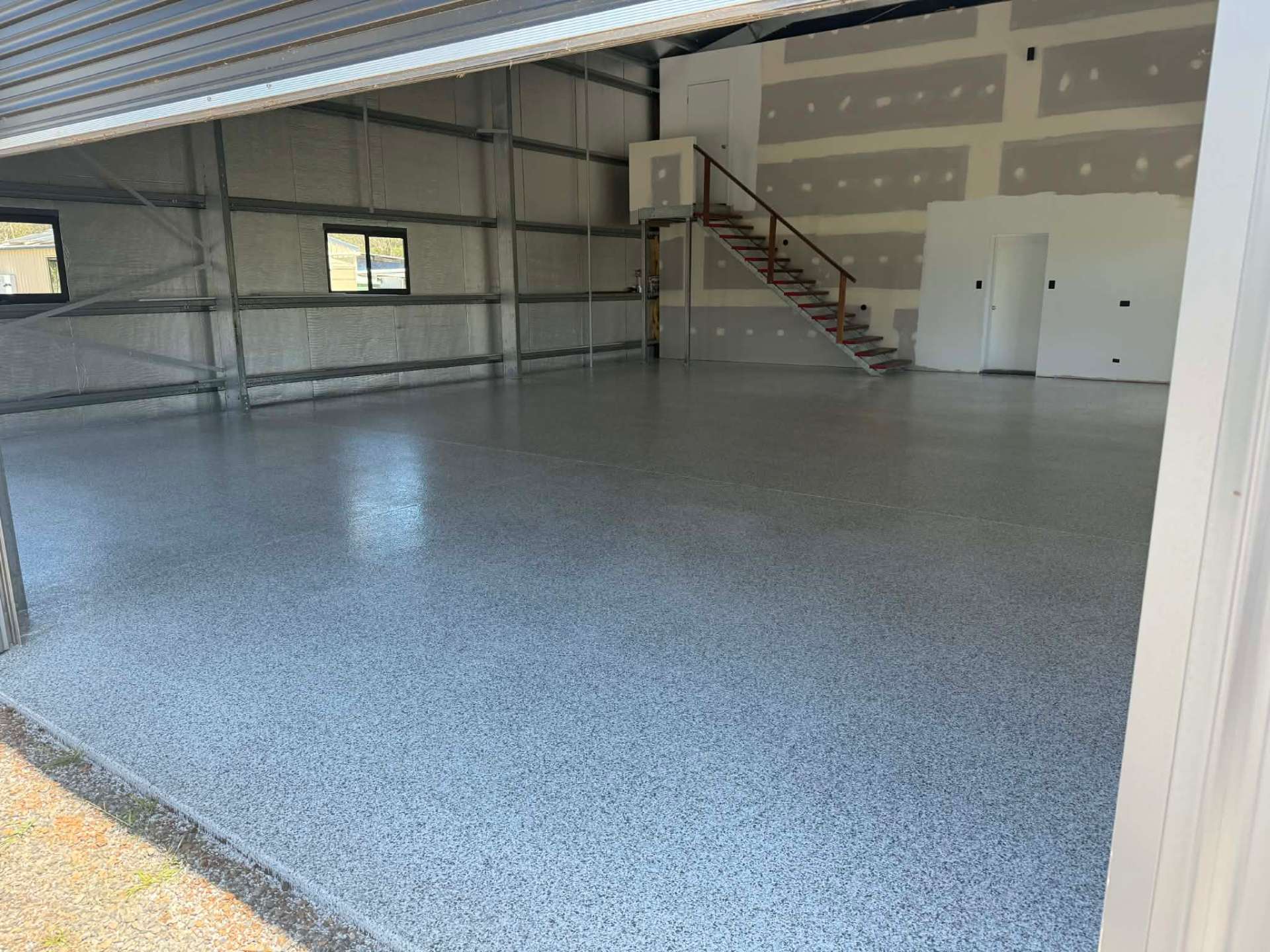 Large garage with grey flake epoxy finish